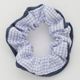 Photo of a blue, plaid print hair scrunchie 