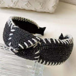 Photo of a black headband with white thread detail