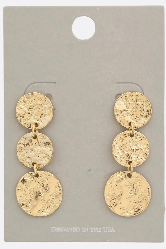 Photo of a gold, hammered metal, triple coin dangle earring 