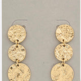 Photo of a gold, hammered metal, triple coin dangle earring 