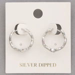 Photo of silver, wavy metal huggie earrings 