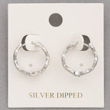 Photo of silver, wavy metal huggie earrings 