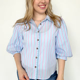 Collared light blue top with pink pin stripes with a touch of white. Button up style. Loose fit. 3/4 length sleeves that have a slight puff look to them.