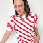 Red and white horizontal striped top. High round neckline with short sleeves. Regular fit. Slight puff in the sleeves.