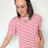 Red and white horizontal striped top. High round neckline with short sleeves. Regular fit. Slight puff in the sleeves.