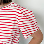 Red and white horizontal striped top. High round neckline with short sleeves. Regular fit. Slight puff in the sleeves.