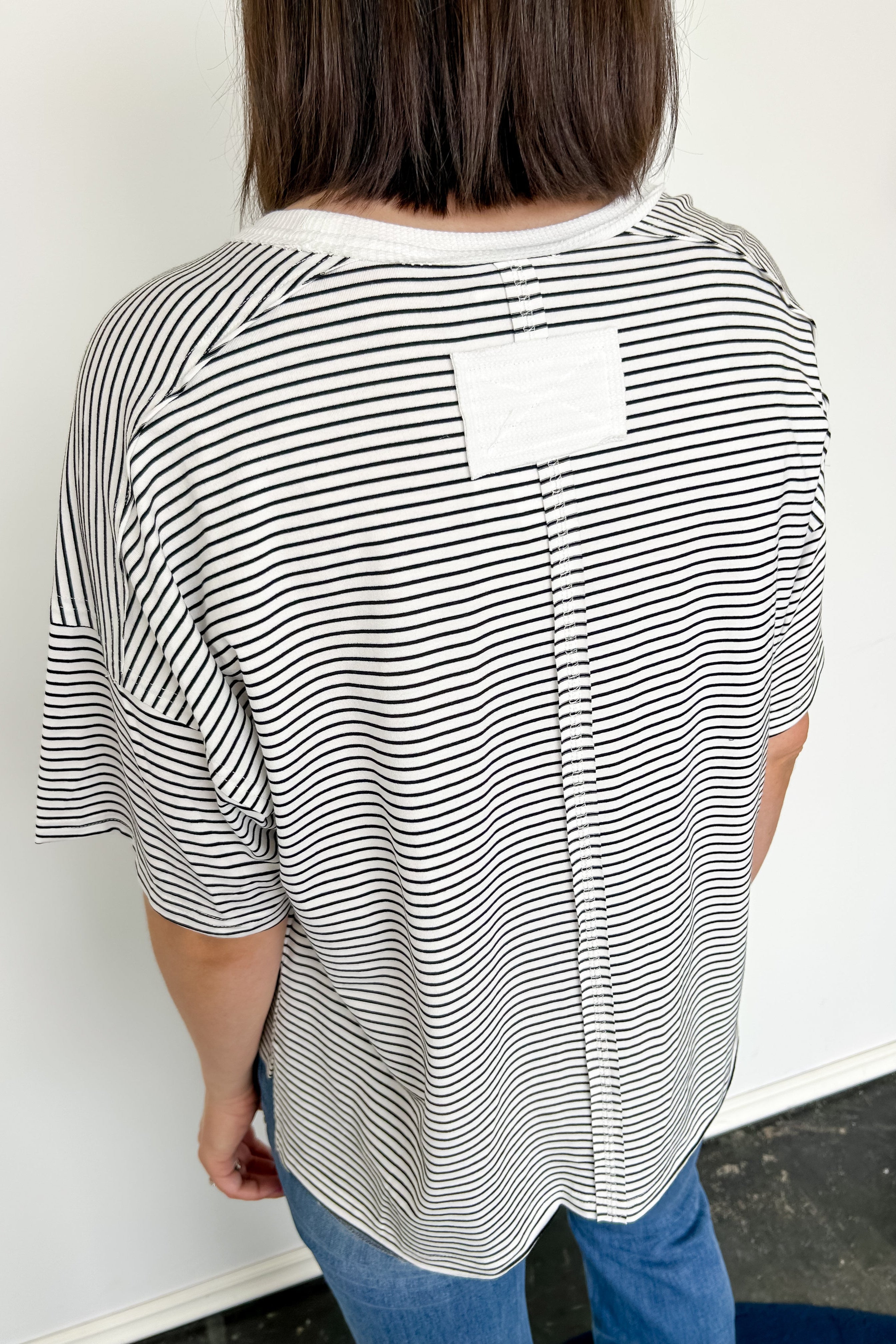 White and black striped tee with ringer neckline. Short sleeve. Oversized fit.