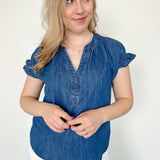 Denim top with slight v neckline and ruffled sleeves. Regular fit. Medium denim in color. Short sleeve. 