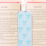 Bookmark with blue bow design on a book page