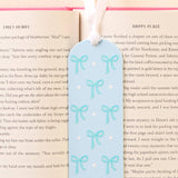 Bookmark with blue bow design on a book page