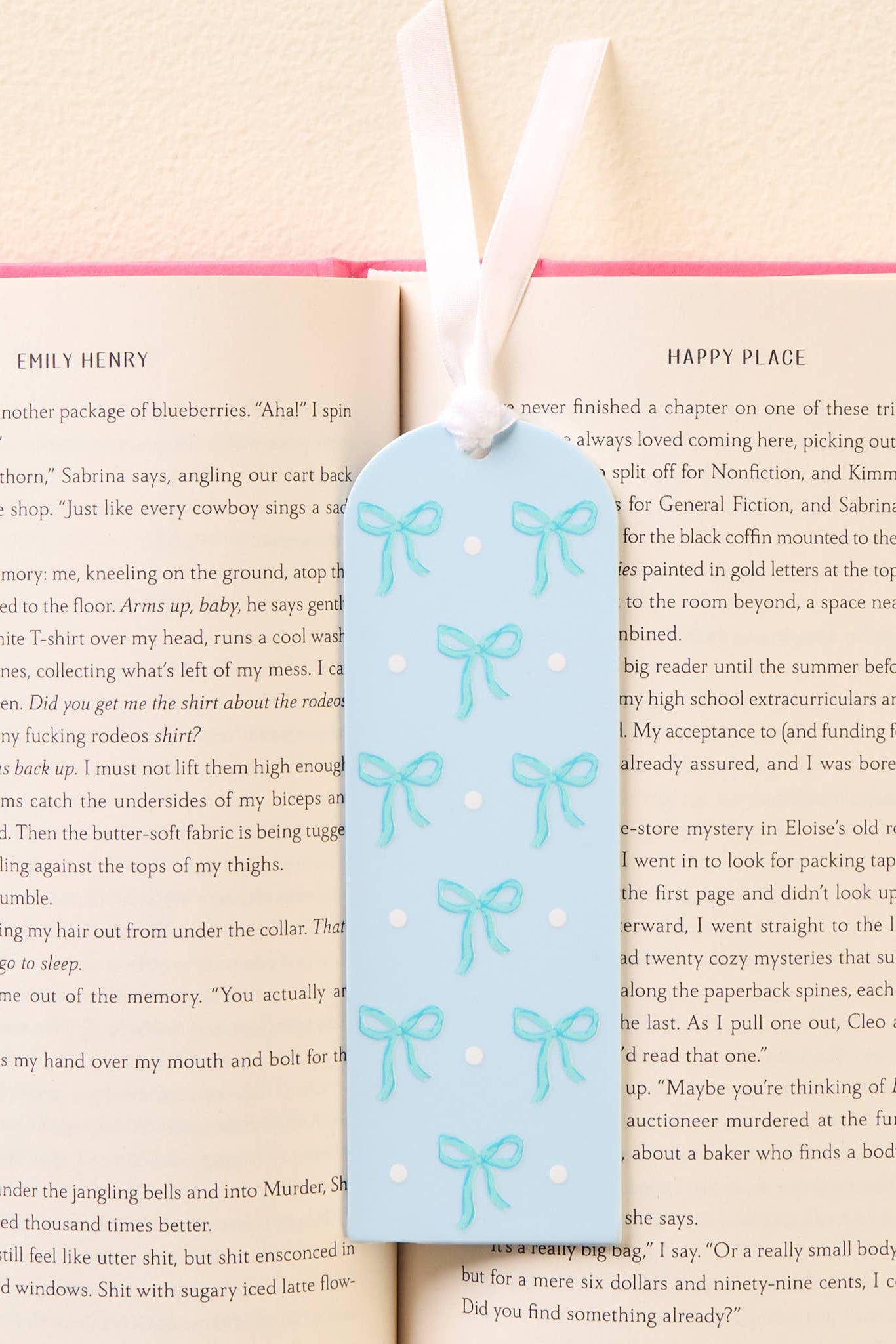Bookmark with blue bow design on a book page