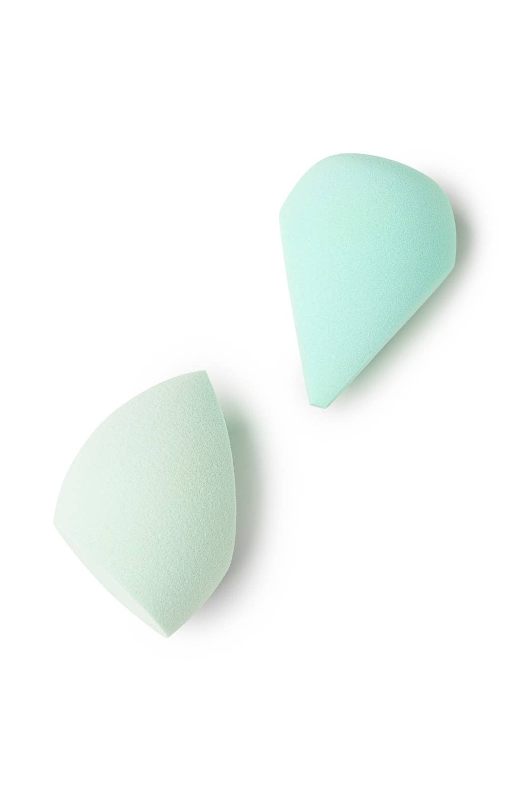 Two light green makeup sponges on a white background