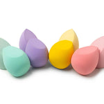 Set of colorful makeup sponges on a white background