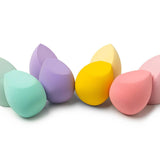 Set of colorful makeup sponges on a white background