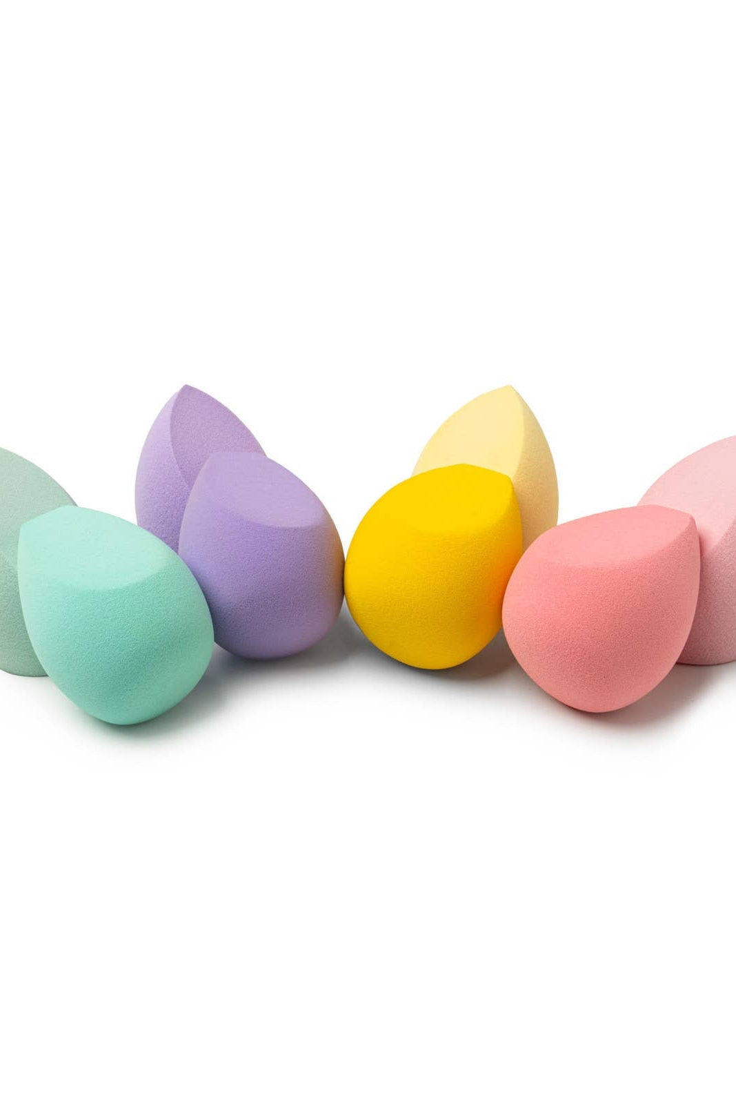 Set of colorful makeup sponges on a white background