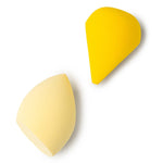 Two yellow makeup sponges on a white background