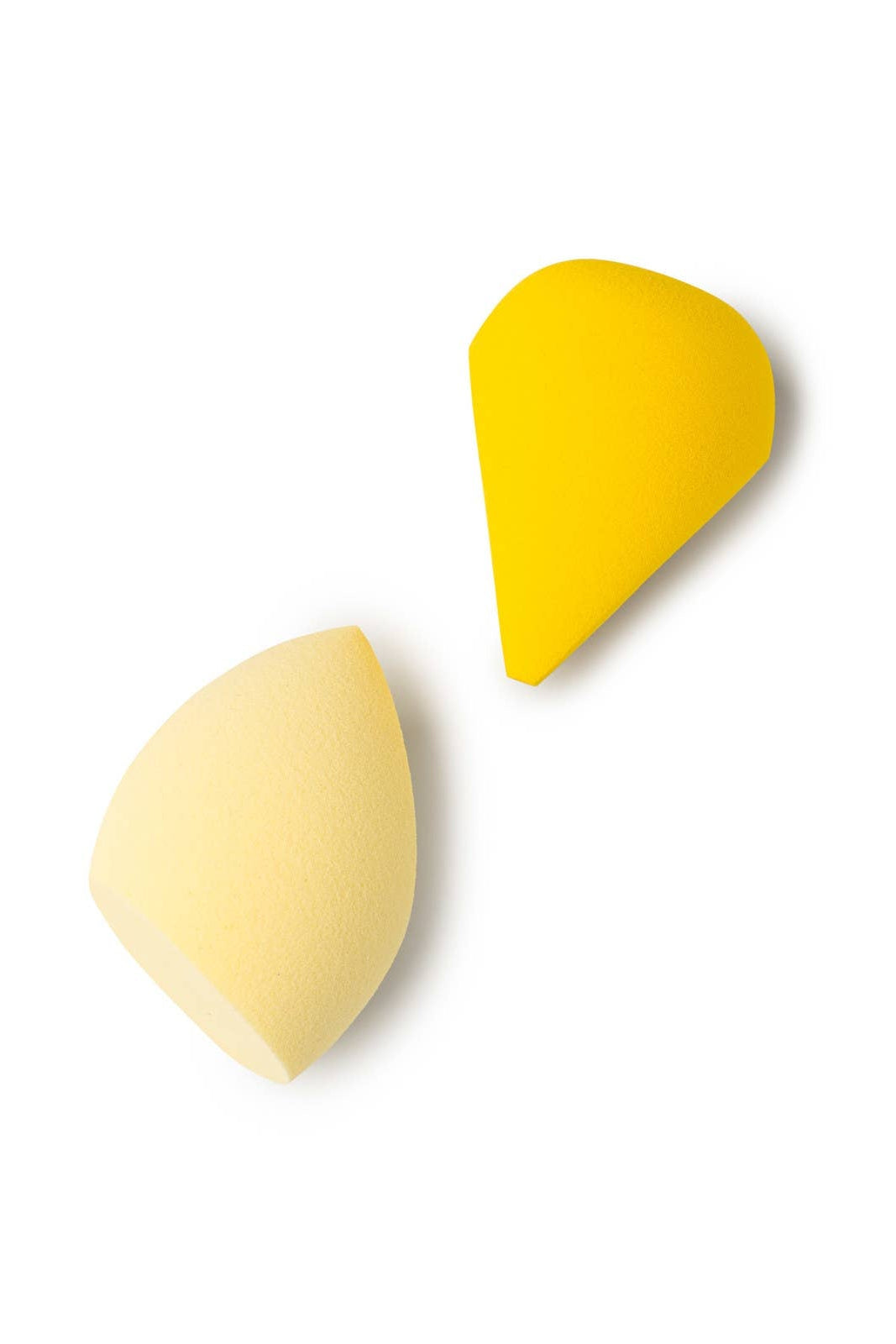 Two yellow makeup sponges on a white background