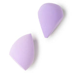Two purple makeup sponges on a white background