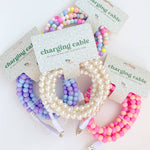 Colorful beaded charging cables on white background
