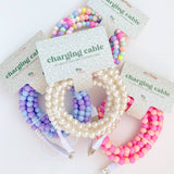 Colorful beaded charging cables on white background