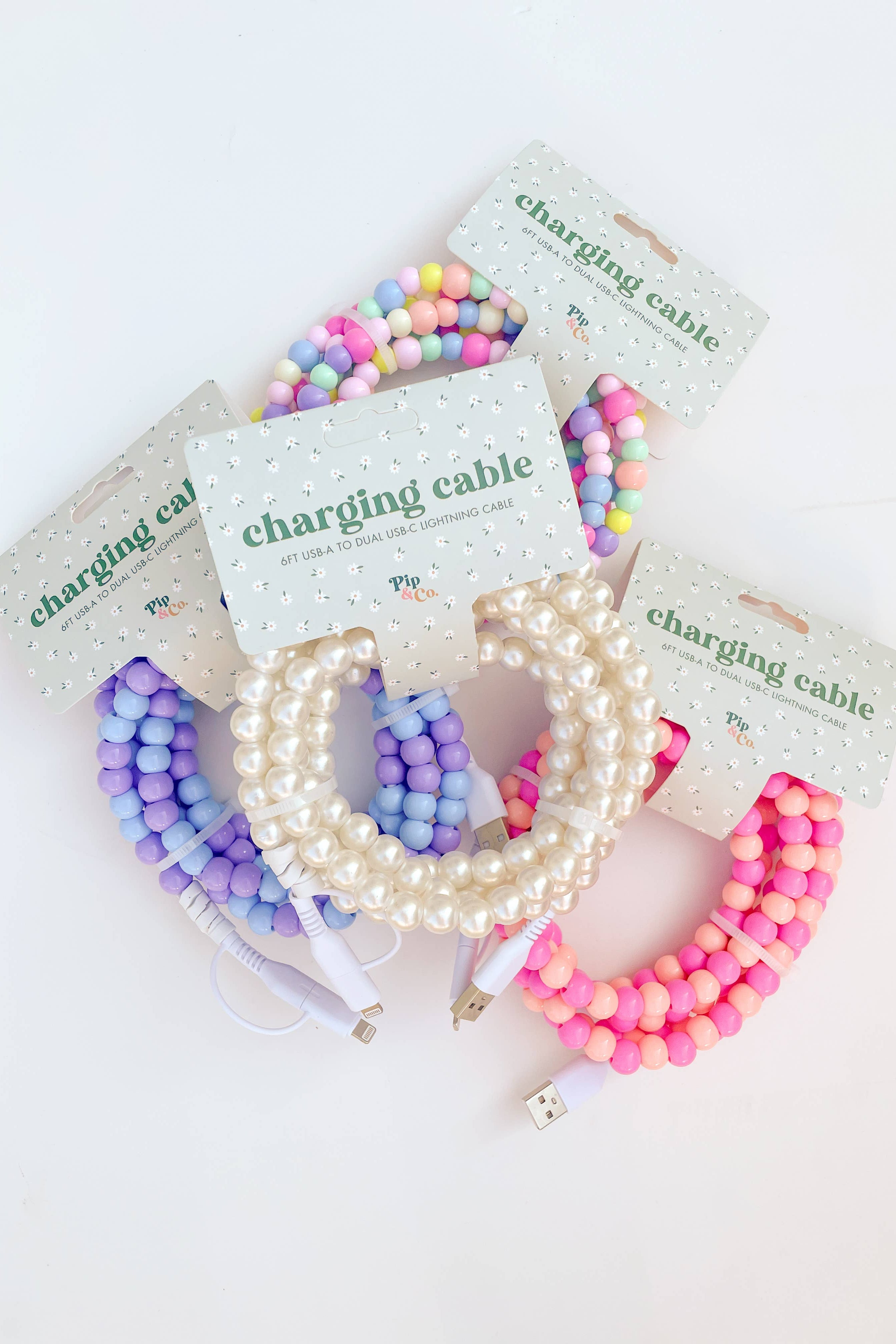 Colorful beaded charging cables on white background