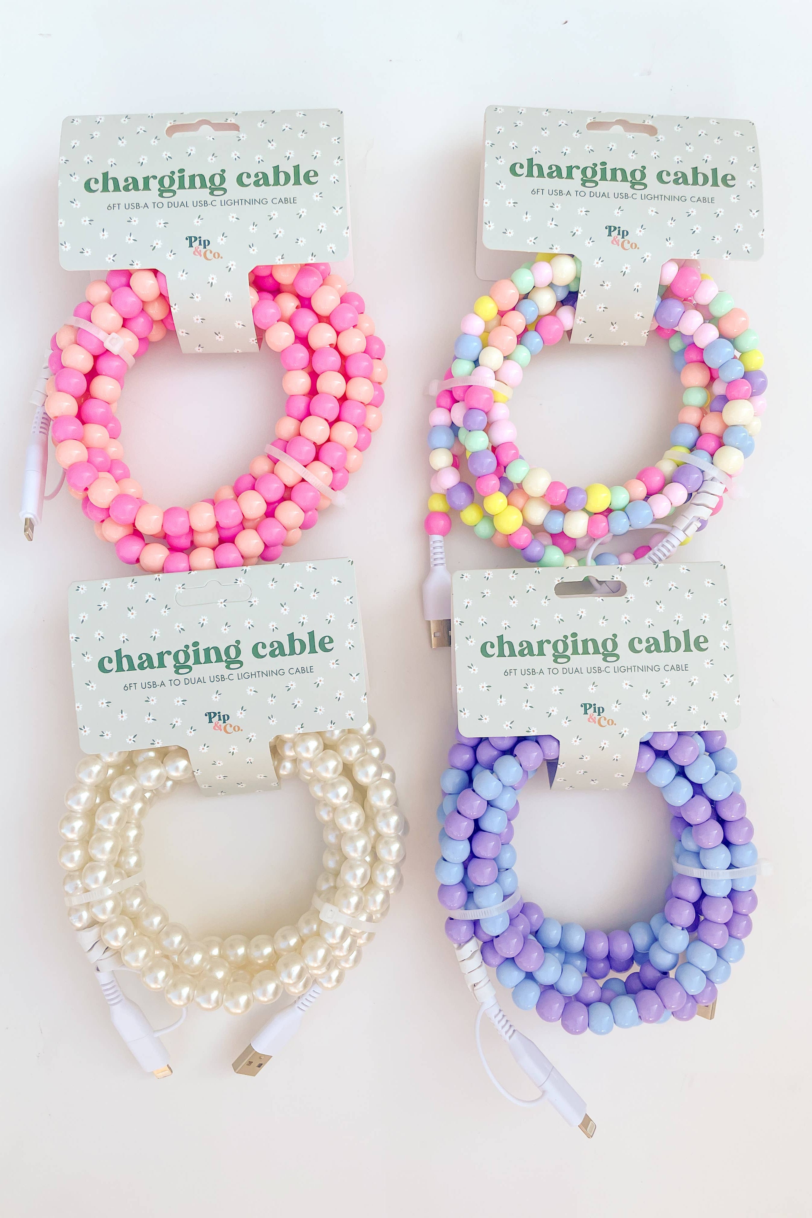 Four charging cable protectors with colorful beads on a white background