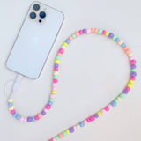 Colorful beaded phone lanyard with a smartphone on a light gray background