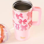 Pink tumbler with bow pattern and pink handle on a beige background