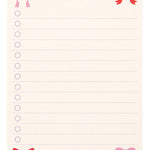 Notepad with colorful bows at the top corner on a white background