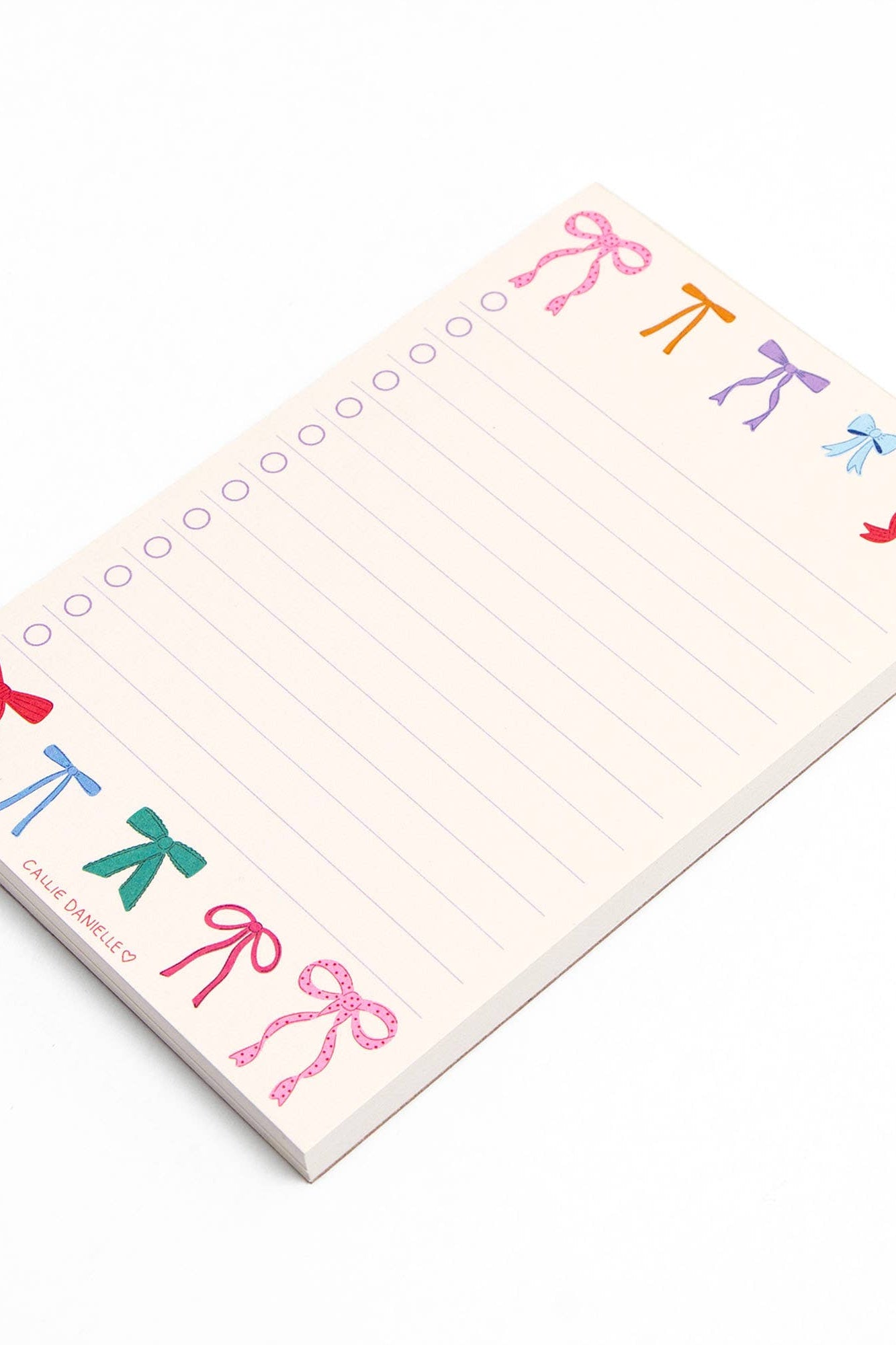 Notepad with colorful bow designs on a white background