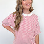 Woman wearing a red and white striped shirt against a white background