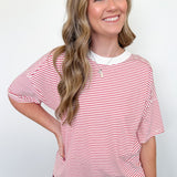 Woman wearing a red and white striped shirt against a white background