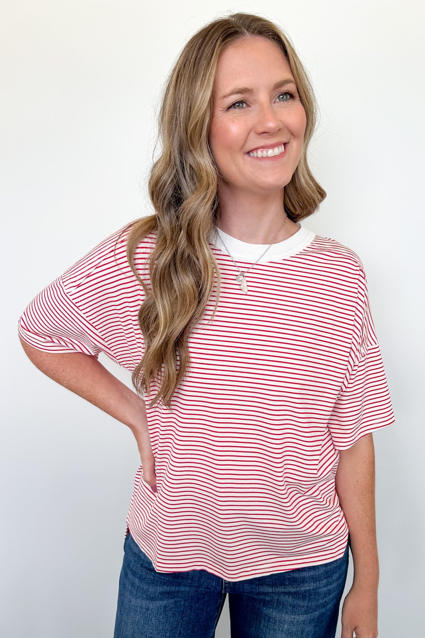 Woman wearing a red and white striped shirt against a white background