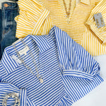 Yellow and blue striped shirts with denim jeans on a white background