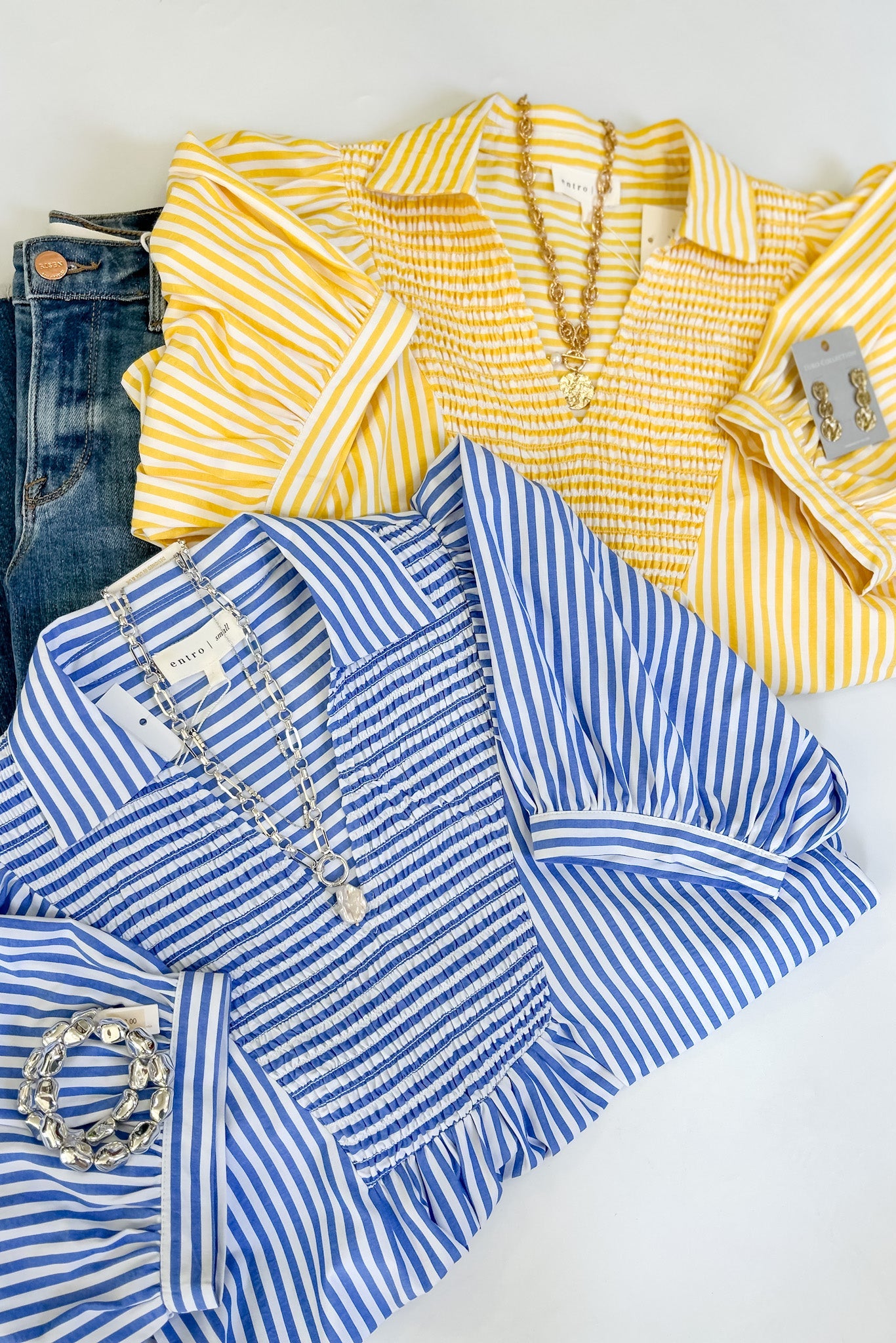 Yellow and blue striped shirts with denim jeans on a white background