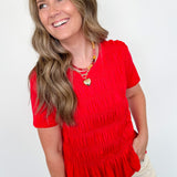 Woman wearing a red blouse with a white background