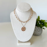 Necklace on a white bust with a blurred background