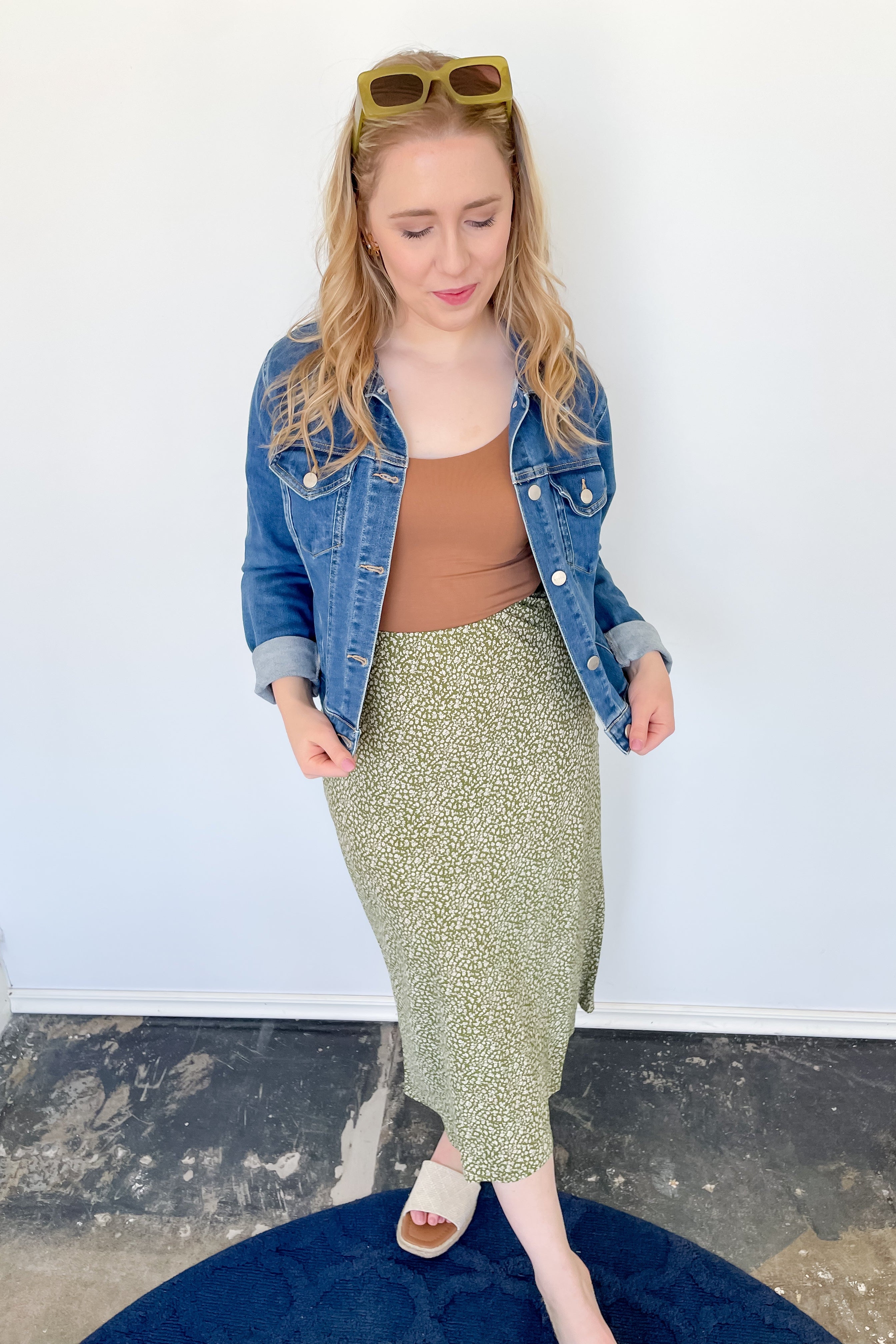 Photo of model wearing a green & white patterned midi skirt
