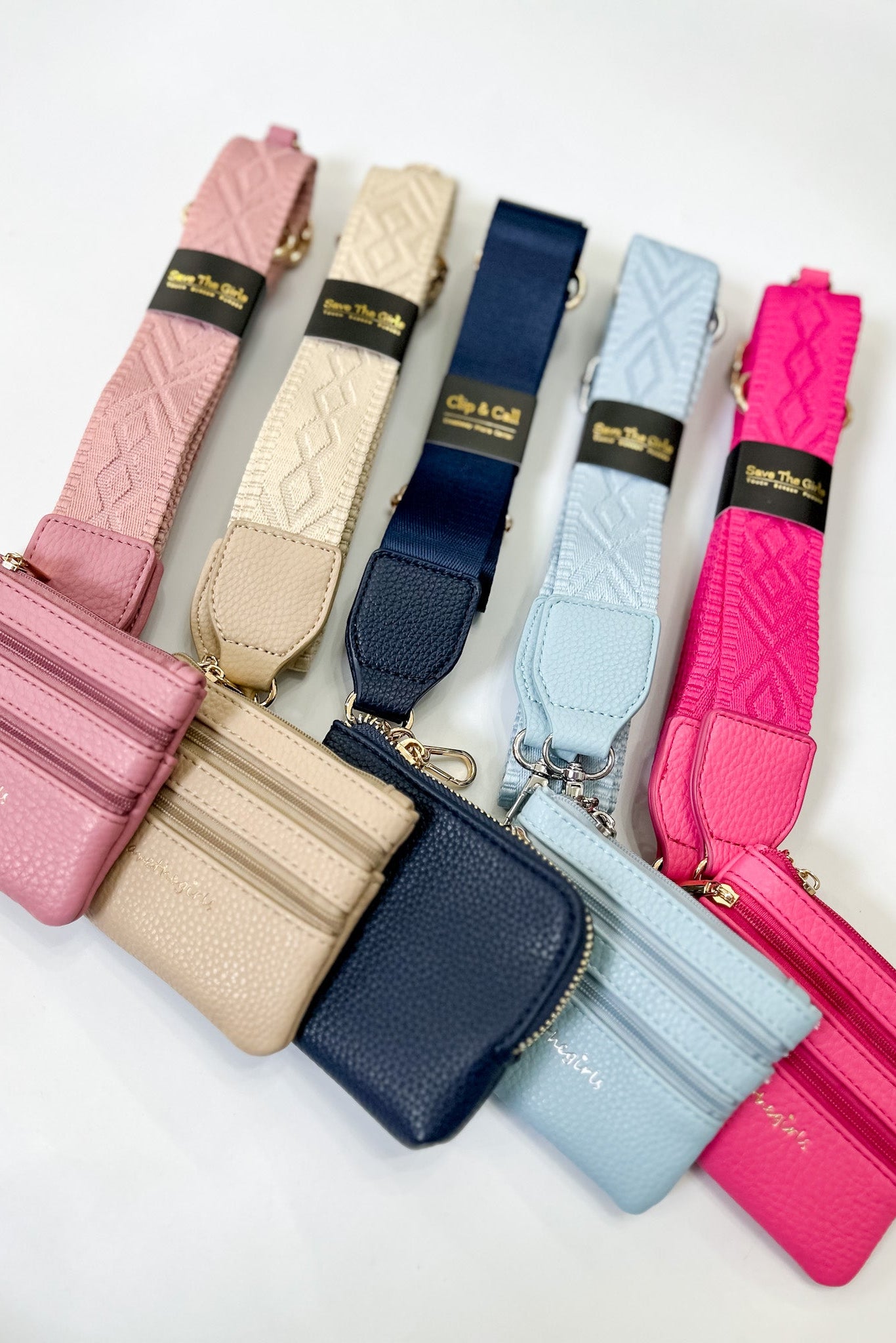 Set of colorful leather wallets with matching straps on a white background