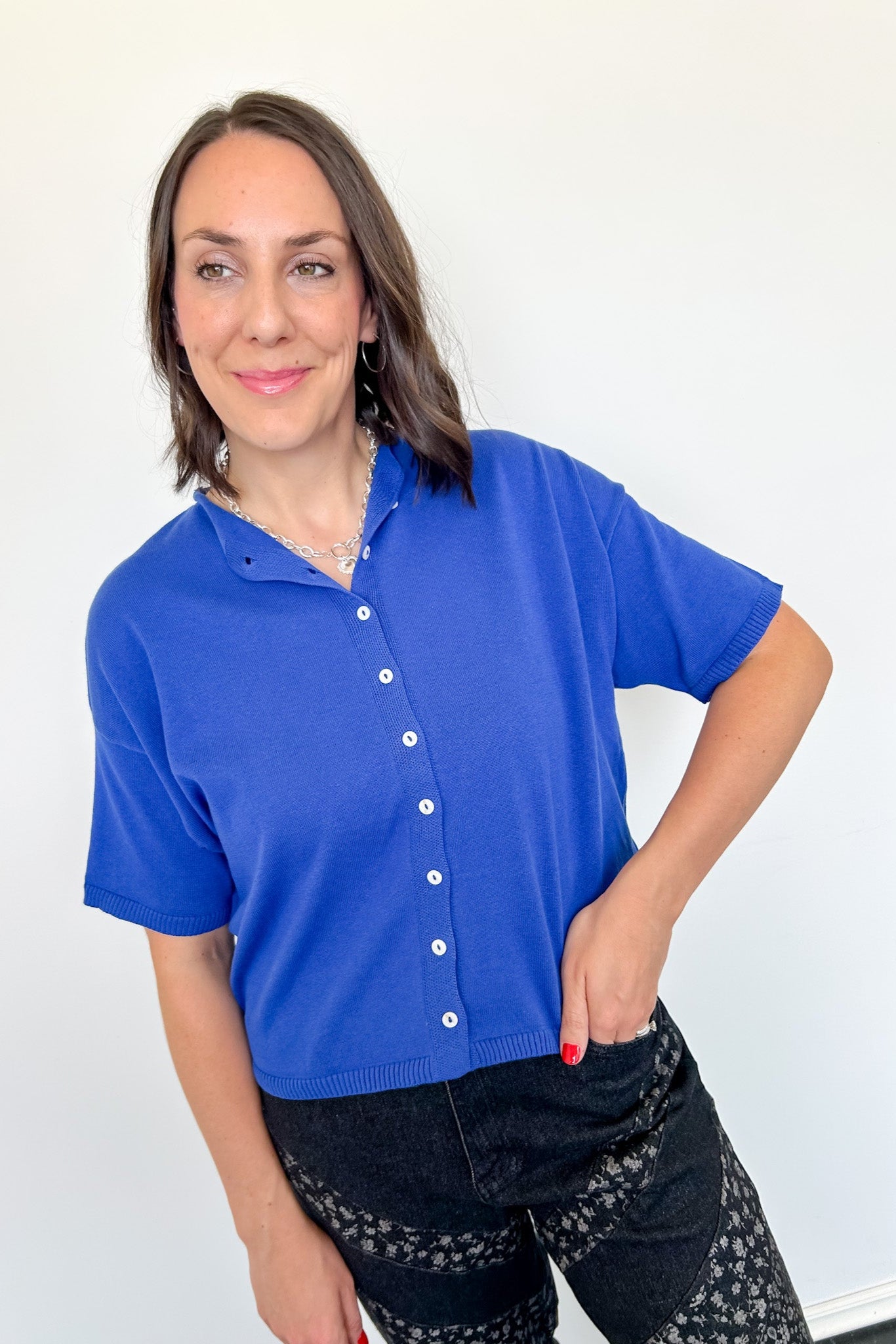 Woman wearing a blue shirt with a white background
