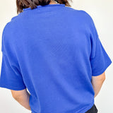 Person wearing a blue sweater against a white background
