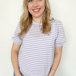 Striped high round neck top. Short sleeve. Regular fit. Slightly puffed sleeves. White and light purple in color.