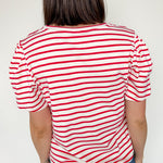 Red and white horizontal striped top. High round neckline with short sleeves. Regular fit. Slight puff in the sleeves.