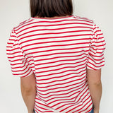 Red and white horizontal striped top. High round neckline with short sleeves. Regular fit. Slight puff in the sleeves.