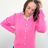 Woman wearing a pink cardigan against a white background