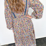 Woman wearing long dress with floral print.