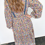 Woman wearing long dress with floral print.