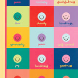 Notebook with colorful square design featuring smiley faces and virtues on a white background