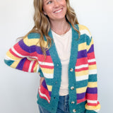 Woman wearing a colorful striped cardigan against a white background
