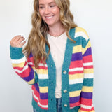 Woman wearing a colorful striped cardigan on a white background